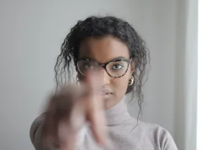 curly woman pointing someone