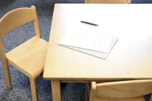 a paper that is placed in desk with a chair